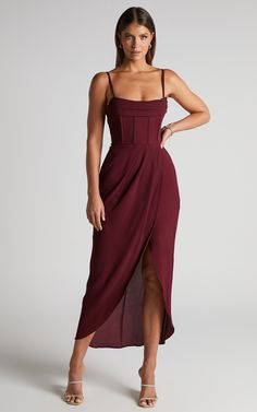 Get ready to turn heads in the stunning Andrina Midaxi Dress. This wine-colored wrap dress is perfect for any formal occasion, whether you're attending a cocktail party, a wedding as a bridesmaid or just looking to impress as a wedding guest. The high low hem adds an elegant touch to this already glamorous dress, and the corset-style top with sweetheart neckline flatters your figure beautifully. Made from polyester, this sleeveless midi dress is both comfortable and stylish. Embrace your inner f