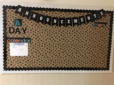 a bulletin board is decorated with black and white polka dot paper, which reads an announcement