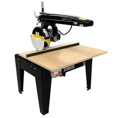 a table sawing machine sitting on top of a workbench with a bench underneath it