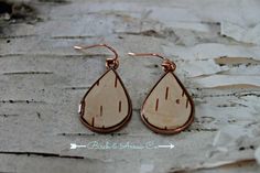 Eco-friendly genuine white birch bark earrings in copper, topped with clear resin. The ear wires are nickel free surgical steel. All of the bark used in our jewellery is ethically sourced and not harvested from live trees. The white birch we used comes from Northern Ontario Canada and carries within it, the energy of our Great Canadian Wilderness. Birch is believed to ward off evil, banish fears and build courage. Associated with beauty and tolerance, it heightens tolerance of oneself and others. The birch tree symbolizes a fresh start and can bring courage and determination to those of us who are treading the path of spiritual growth. These forest child earrings are set in copper. They measure approx 1 inch long. No two are alike due to the unique nature of birch bark. Birch Bark Earrings, Birch Art, Canadian Wilderness, Antler Earrings, Northern Ontario, Live Tree, White Birch, Unique Nature, Birch Bark