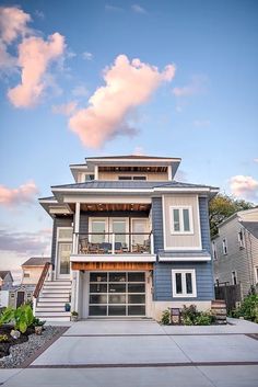 a blue and white two story house with an attached garage