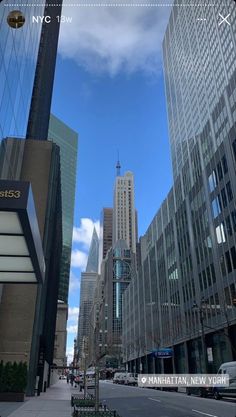 an empty city street with tall buildings in the background