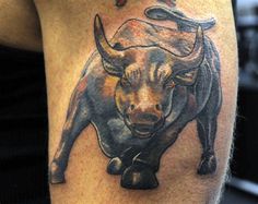 a man with a bull tattoo on his arm