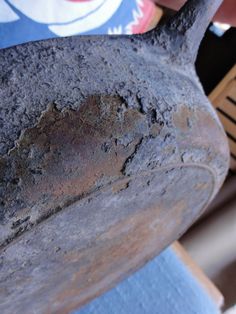 a person is holding an old pottery pot