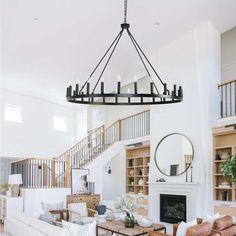 a living room filled with furniture and a large chandelier hanging from the ceiling