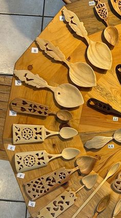 wooden spoons and spatulas are arranged on a table