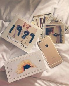 an iphone and some photos on a bed