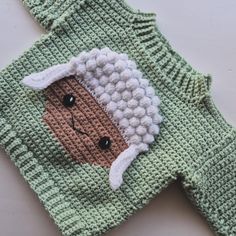 a crocheted sweater with a sheep on it