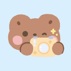 a brown teddy bear holding a camera in its paws and looking at it's face