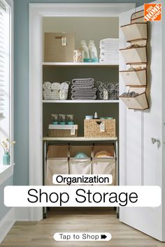 an organized shop storage area with baskets, towels and other items on shelves in front of the door