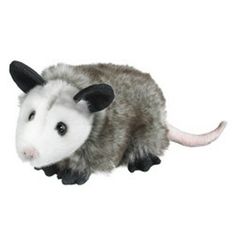 an opossmus stuffed animal sitting on top of a white surface with one eye open