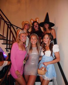 a group of women dressed in costumes posing for the camera