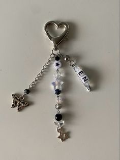 a keychain with charms attached to it and a heart shaped charm hanging from the end