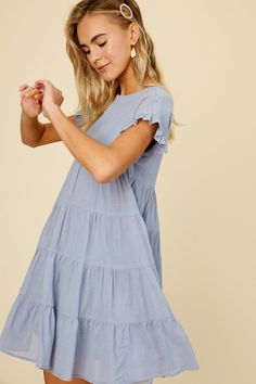 -Color: Misty Blue -Linen textured cotton woven fabric -Round neck -Ruffle short sleeves -Keyhole on back with button -Side seam pockets -Lined -Imported -Maternity friendly style -Content: Self 100% Cotton, Lining 100% Polyester -Runs true to size -Model is 5' 10" 33-24-35 and wearing a size Small Casual Ruffled Short Sleeve Dress For Day Out, Casual Short Sleeve Dress With Ruffles For Day Out, Casual Short Sleeve Blue Cotton Dress, Modest Cotton Dress With Short Sleeves, Cotton Short Sleeve Dress For Day Out, Maternity Dresses With Short Sleeves, Short Sleeve Maternity Dresses For Summer, Casual Maternity Cotton Dress, Short Sleeve Maternity Dresses With Ruffles