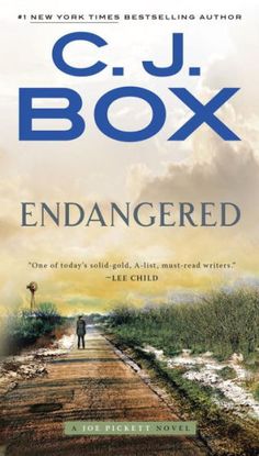 an image of the book cover for endangered by c j box, with a person standing on a dirt road