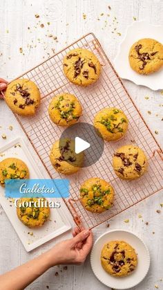 cookies cooling on a wire rack next to two plates with chocolate chip cookies in them