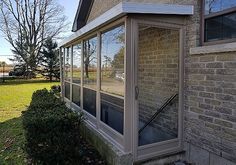 an outside view of a house with large windows