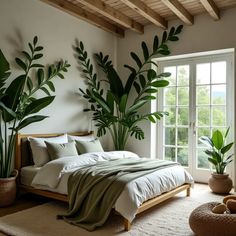 a bedroom with large plants on the wall