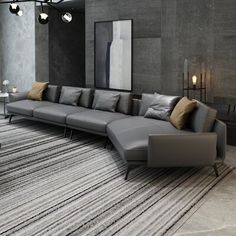 a modern living room with grey couches and rugs