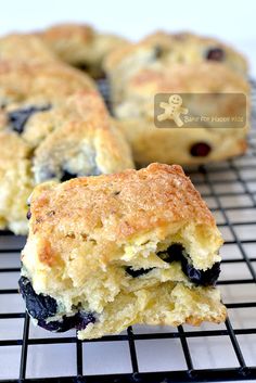 blueberry scones on a cooling rack with one cut in half to show the filling