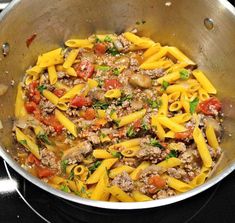 a pan filled with pasta and meat on top of a stove