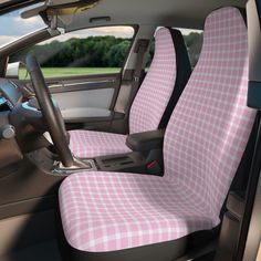 the interior of a car with pink and white checkered cloth on the seat covers