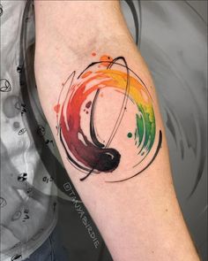 a man's arm with a colorful tattoo on the left side of his arm