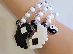 These kandi bracelets are made with black and white pony beads and yin yang charms. These are made in all different sizes. One size fits most. Perfect for any event! You will get lots of compliments in this unique wearable art! Stand out at your next event! Edm festival  Raves Party  Rave outfit  Festival outfit Pride Party favors  Birthday gifts Stocking stuffer  Rave anniversary  Rave gift Cheap Black Rave Bracelets, Novelty White Stretch Bracelet With Round Beads, White Novelty Stretch Bracelet With Round Beads, White Beaded Novelty Stretch Bracelet, White Novelty Beaded Stretch Bracelet, White Novelty Stretch Bracelet For Friendship, Handmade Black Beaded Bracelets For Rave, Handmade White Beaded Rave Bracelets, White Handmade Beaded Bracelets For Rave