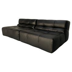 a black leather couch on a white background