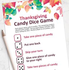 a thanksgiving candy dice game is shown on a table with a pencil and paper next to it