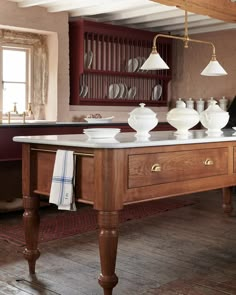 a large kitchen island with white dishes on it