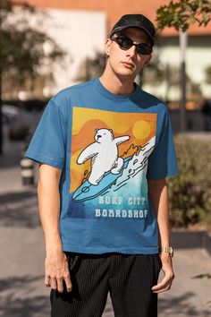 EXCLUSIVE OF DESIGN. MADE-TO-ORDER.Surf City Boardshop Polar Bear Mascot - Sunset Edition Heavyweight Tee. The unisex heavy cotton tee is the basic staple of any wardrobe. Printed on a thicker, 6.1 oz cotton jersey, the design is made to last. The specially spun 100% cotton fibers provide a smooth surface for premium vividity and sharpness. No side seams mean for extra comfort. For added durability and to prevent dropping, shoulders taping is applied. Details 100% cotton jersey (fiber content ma Sporty Crew Neck T-shirt For Surfing, Graphic Tee T-shirt For Surfing With Relaxed Fit, Graphic Tee With Relaxed Fit For Surfing, Relaxed Fit Graphic Tee For Surfing, Surfing Graphic Tee With Crew Neck, Relaxed Fit Crew Neck Surfing T-shirt, Relaxed Fit Crew Neck T-shirt For Surfing, Casual Surfing T-shirt With Graphic Print, Casual Cotton Surfing T-shirt