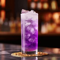 a purple drink sitting on top of a table