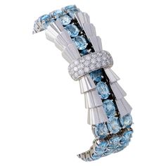 Dating from the 1930s, this Tiffany & Co. aquamarine and diamond bracelet was made in France. It is designed as strap of flexible oval-cut aquamarines, approximate total weight 32.40 carats, centering a stepped platinum ribbon bow with pavé-set diamond band, and completed by a buckle clasp. Stylized and flowing, with sparkling diamond highlights, this bracelet sits balanced on the wrist, its cool blue and matte platinum streamlined form both playful and dynamic. Product Details: Item #: BA-20586 Artist: Tiffany & Co. Country: France Circa: 1930's Dimensions: 6.5" length x 0.75" width Materials: 32 round diamonds (with approximate total weight 1.25 carats); 54 oval aquamarines (with approximate total weight 32.40 carats); Platinum Signed: Tiffany & Co from France. Importation mark Macklowe Platinum Bracelet, Art Deco Brooch, Diamond Bows, Art Deco Bracelet, Three Stone Diamond, Gold Cufflinks, Diamond Brooch, Gold Cuffs, Tiffany And Co