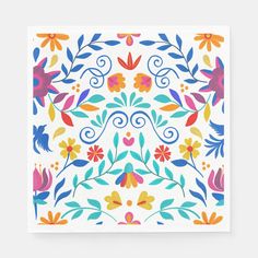 a square paper napkin with colorful flowers and leaves on the front, printed in bright colors