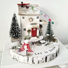 a small white house with christmas decorations on it