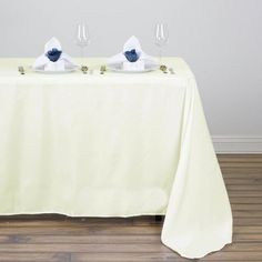 two glasses are sitting on top of a table with a white cloth draped over it