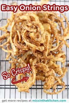 some onion rings on a cooling rack with the words easy onion strings so crispy