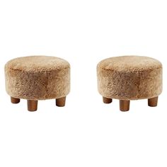 two small stools made out of sheep fur