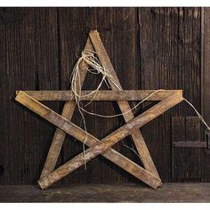 a wooden star hanging on the side of a building