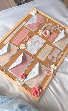 a close up of a tray on a bed with paper flowers and cards attached to it