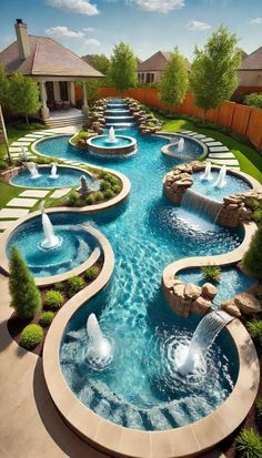 an outdoor swimming pool with water features in the center and waterfalls on each side