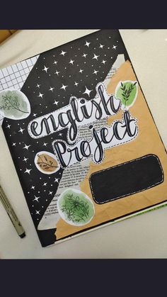 an open notebook with the words english project written on it next to a pen and scissors