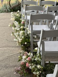 rows of chairs lined up with flowers on them