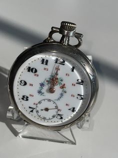 C. Crettiez sterling French late 1800's open face pocket watch. This fabulous find has a fancy floral porcelain dial , with 24 hour marks, a sub seconds dial at the 6o'clock, and gold dots all the way around the edge. The cylinder movement is a 15 jewel pin set stem wind and works beautifully. The fancy etched back has rose gold and yellow gold overlay, on the shield is rose gold while the flowers are yellow gold. This watch is in excellent condition inside and out. Fob Watch, Vintage Pocket Watch, Antique Watches, Gold Dots, Girly Accessories, Vintage Clock, Sentimental Gifts, Pocket Watch, Vintage Watches