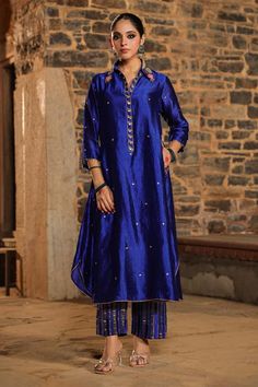 Blue shirt style kurta with all over floral pattern, contrast zari, pearl, resham and sequin intricate cheent embroidery. Paired with zari stripe woven palazzo. - Aza Fashions Blue Semi-stitched Silk Palazzo Set, Blue Raw Silk Kurta For Party, Blue Festive Palazzo Set With Straight Kurta, Blue Palazzo Set With Dori Work, Blue Raw Silk Party Kurta, Elegant Blue Palazzo Set With Straight Kurta, Traditional Blue Palazzo Set For Transitional Season, Traditional Blue Palazzo Set For Festive Season, Traditional Blue Palazzo Set For Festive Occasions