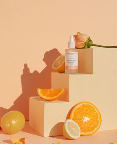 an assortment of oranges, lemons and facial care products arranged on top of each other