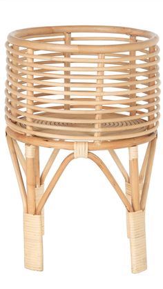 a round wicker basket with wooden legs