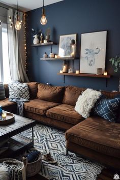 a living room filled with brown couches and pillows on top of a wooden table