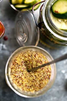 two jars filled with food sitting on top of a table